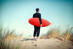 Surfer on a beach for an corporate incentive trip